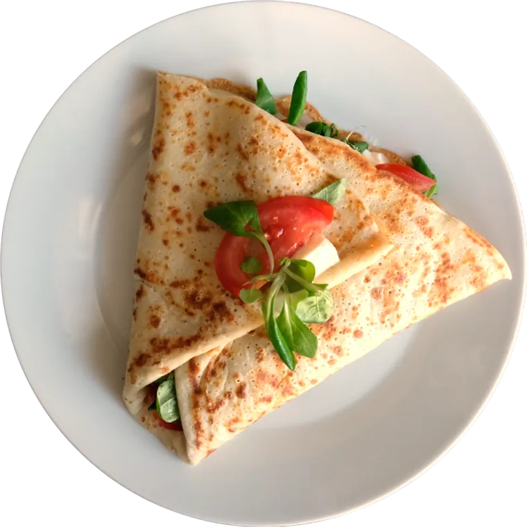 Slaná palačinka Capresse s mozzarellou a rajčaty na bílém talíři